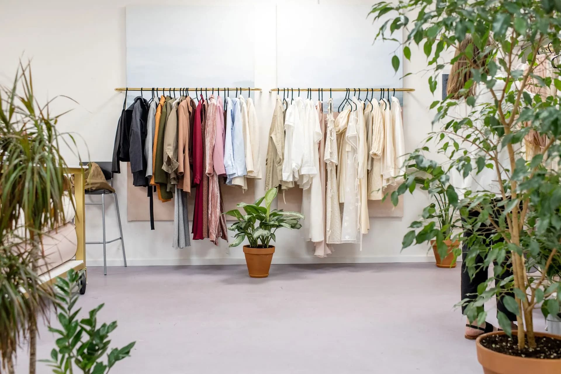 Boutique shop floor with plants and clothing racks — put the inventory you already sell online.